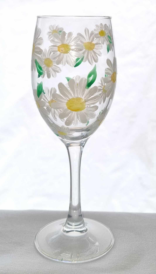 Wine glass with daisy flower pattern on a white background