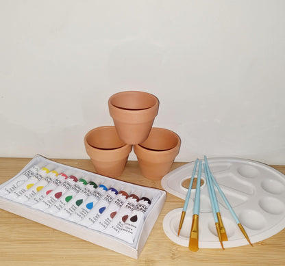 DIY mini pot painting kit with pots, paints, brushes, apron, and step-by-step instructions by Creative Box
